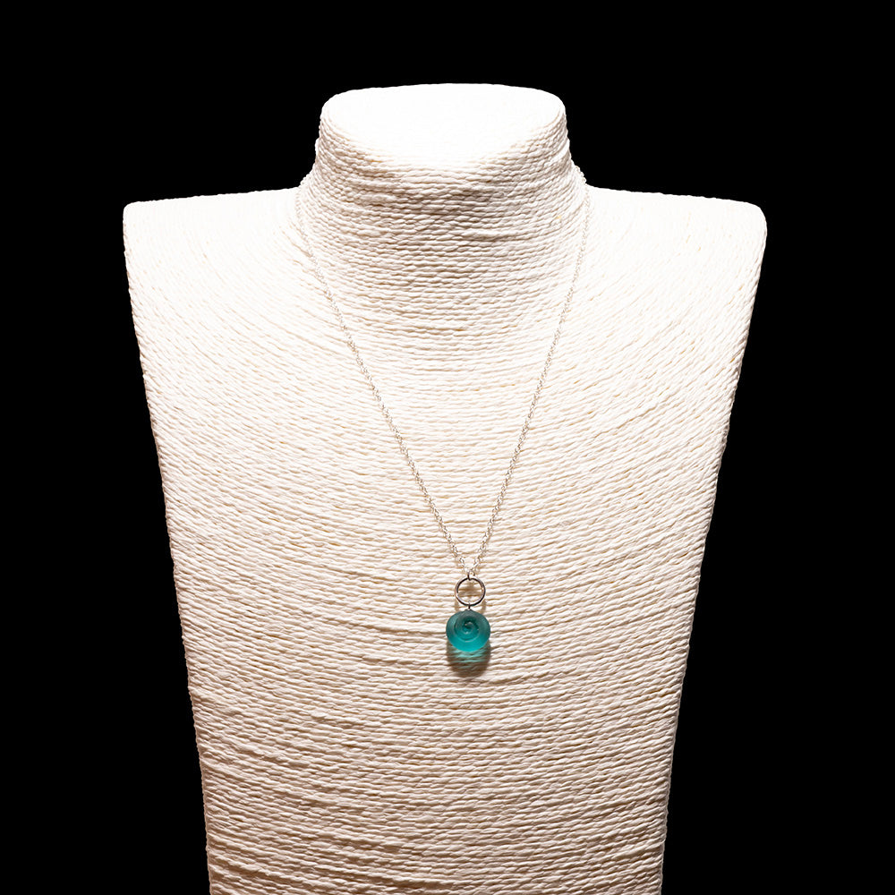 teal glass swirl charm necklace with sterling silver chain shown on a white mannequin bust