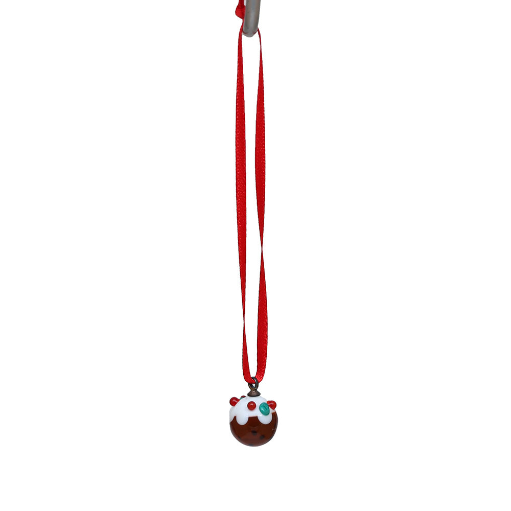 Tiny glass christmas pudding decoration hanging on a red ribbon.