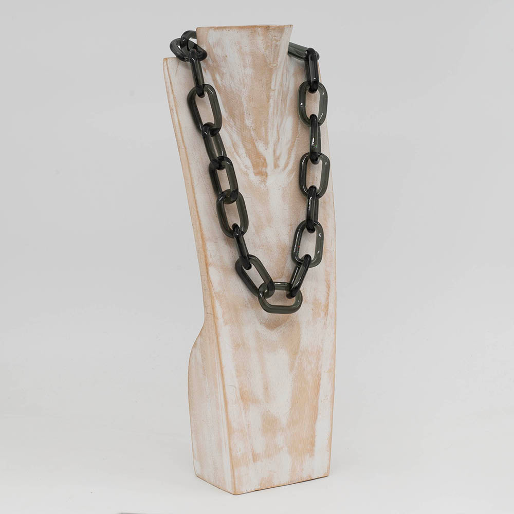 Whitewashed wood torso displaying a necklace made from chunky transparent glass links