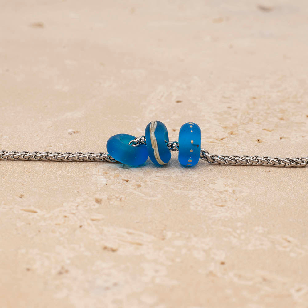 Three frosted turquoise glass beads on a stainless steel chain