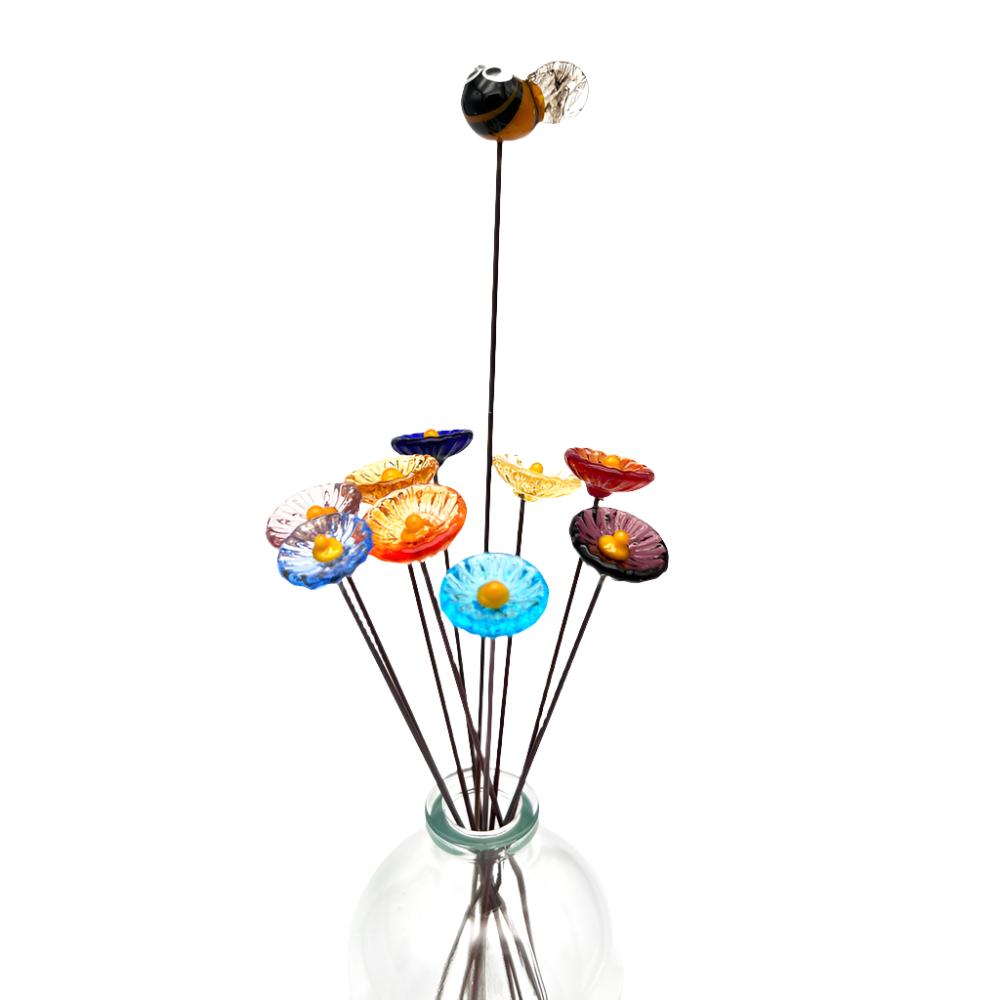 close up glass bee and nine daisy flowers in a vase